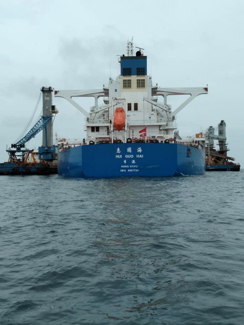 Bulk carrier during transshipment, floating cranes alongside